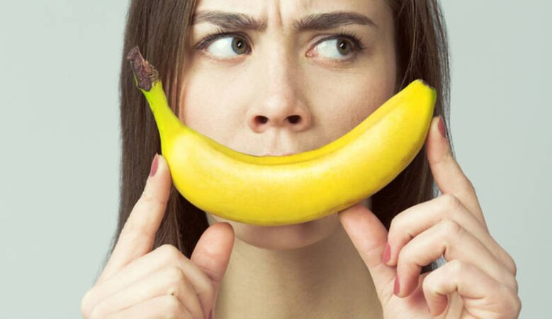 Une fille à la banane imite l'agrandissement du pénis avec un massage
